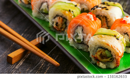 Sushi set: sushi roll with salmon and sushi roll with smoked eel. Sushi set: sushi roll with salmon and sushi roll with smoked eel. 138162633