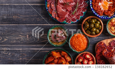 Typical spanish tapas concept, rustic style, top view. Typical spanish tapas concept, rustic style, top view. 138162652