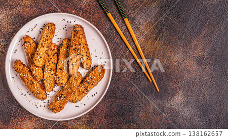 Fried tempeh with sesame seeds. Fried tempeh with sesame seeds. 138162657