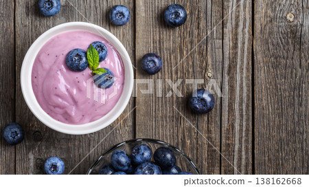 Homemade yogurt with fresh blueberry on a wooden background. Homemade yogurt with fresh blueberry on a wooden background. 138162668