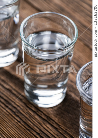 Vodka shot glass close up on wooden Vodka shot glass close up on wooden 138162706