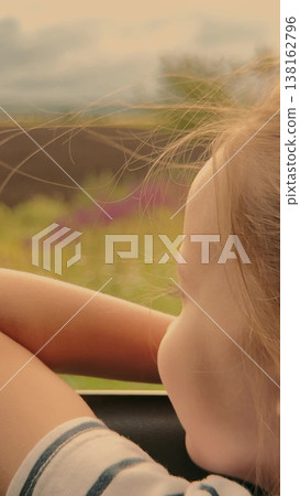 Kid enjoying the ride, Gentle breeze through the car, Quiet moments on a long drive, Gazing at the fields, Imagination running wild, Golden hour light on her face, Calm and serenity, Nature outside Kid enjoying the ride, Gentle breeze through the car, Quiet moments on a long drive, Gazing at the fields, Imagination running wild, Golden hour light on her face, Calm and serenity, Nature outside 138162796