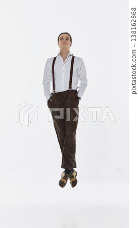 Man floating vertically in air on white background with relaxed posture Man floating vertically in air on white background with relaxed posture 138162868