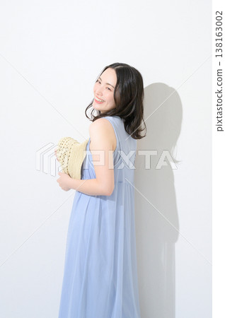 Japanese woman holding a hat against a white background Japanese woman holding a hat against a white background 138163002