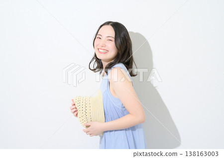 Japanese woman holding a hat against a white background Japanese woman holding a hat against a white background 138163003