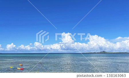 Ie Island and majestic cumulonimbus clouds as seen from the rocky coast of Bisezaki, Okinawa. Ie Island and majestic cumulonimbus clouds as seen from the rocky coast of Bisezaki, Okinawa. 138163063