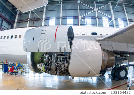 Close-up of an open high bypass turbofan airplane engine of a passenger aircraft in aviation hangar Close-up of an open high bypass turbofan airplane engine of a passenger aircraft in aviation hangar 138164422