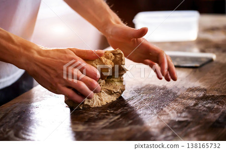 Person hands kneading dough on wooden table preparing bread for baking baking process preparation of artisan whole grain bread close up of cooking ingredient Person hands kneading dough on wooden table preparing bread for baking baking process preparation of artisan whole grain bread close up of cooking ingredient 138165732