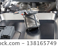 Accumulation of food particles on dirty mesh filter of dishwasher requiring maintenance and cleaning of appliance component for optimal function 138165749