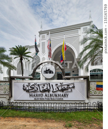 Al-Bukhari Mosque sign and entrance with flags and palm trees, Kuala Lumpur, Malaysia 138165769