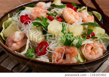 Thai salad with shrimp and rice noodles, pineapple slices, coriander and mint leaves, homemade , no people, 138165902