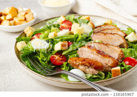 Caesar salad, with duck breast, on a light plate, on a light background, homemade, no people, Caesar salad, with duck breast, on a light plate, on a light background, homemade, no people, 138165907