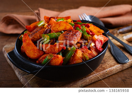 Steakhouse pfanne, fried potato slices, with meatballs, and vegetable mixture, on a black plate, Steakhouse pfanne, fried potato slices, with meatballs, and vegetable mixture, on a black plate, 138165938