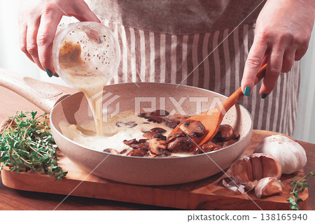 cooking sauce with mushrooms, a woman pours cream into a pan with mushrooms, natural light, lifestyle, cooking sauce with mushrooms, a woman pours cream into a pan with mushrooms, natural light, lifestyle, 138165940