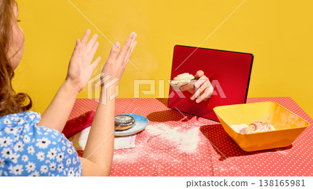 Woman clapping hands as tart appears from tablet screen on flour covered table. Woman clapping hands as tart appears from tablet screen on flour covered table. 138165981