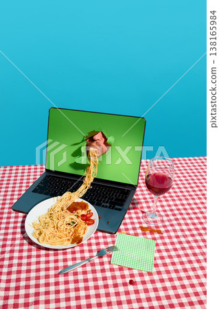 Spaghetti flowing from mouth inside laptop screen onto plate on checkered table with wine Spaghetti flowing from mouth inside laptop screen onto plate on checkered table with wine 138165984