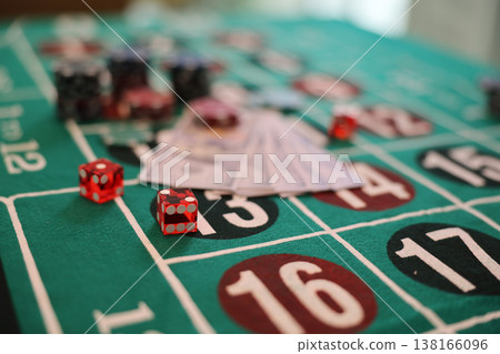 Exciting moments at the casino with colorful chips and dice on the roulette table during a lively evening gathering Exciting moments at the casino with colorful chips and dice on the roulette table during a lively evening gathering 138166096