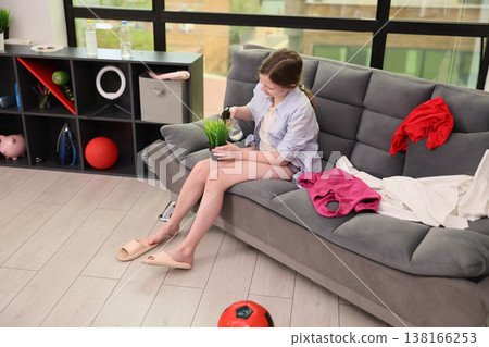 Plant care and cozy moments in a bright living room during a sunny afternoon 138166253