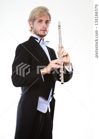 Male flutist wearing tailcoat holds flute Male flutist wearing tailcoat holds flute 138166379