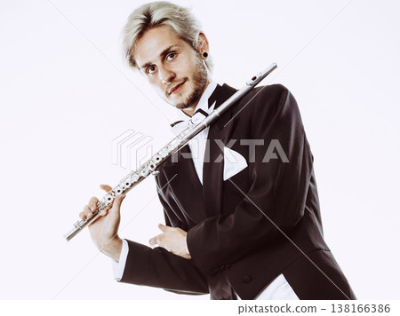 Male flutist wearing tailcoat holds flute Male flutist wearing tailcoat holds flute 138166386