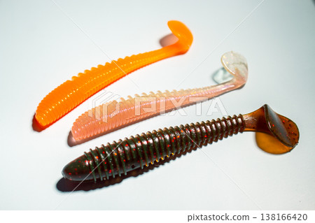Flat lay of fishing equipment on white background. Close up of custom worms 138166420