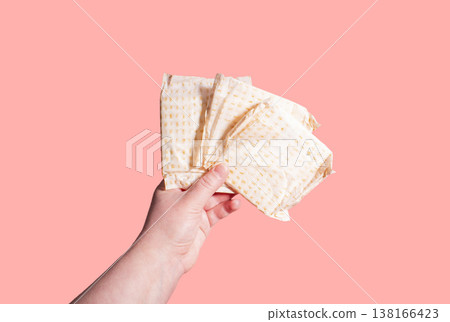 Classic menstrual pads in woman hand. Menstrual cycle and suffering from menstrual pain. Female period and intimate hygiene Classic menstrual pads in woman hand. Menstrual cycle and suffering from menstrual pain. Female period and intimate hygiene 138166423