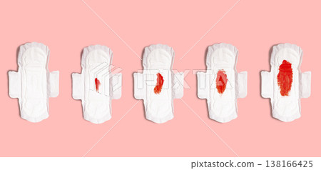 Menstrual cycle from first day to fifth day. Menstrual pads with blood in row on pink background. Female health concept Menstrual cycle from first day to fifth day. Menstrual pads with blood in row on pink background. Female health concept 138166425
