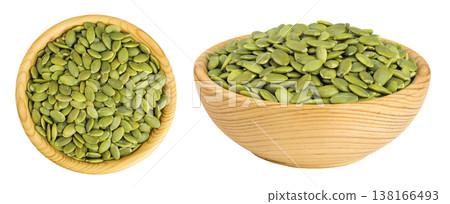 Peeled pumpkin seeds in wooden bowl isolated on white background. Top view. Flat lay 138166493