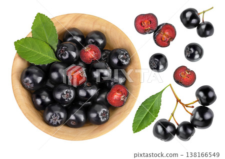 Chokeberry with leaf in a wooden bowl isolated on white background. Black aronia. Top view. Flat lay 138166549