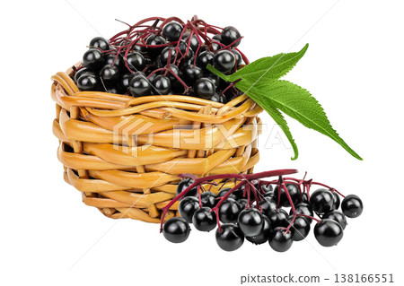 Ripe black elderberry or elder with green leaves in a wicker basket isolated on a white background. Sambucus 138166551