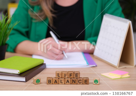 Focusing on life balance while writing in a cozy workspace with plants and notes in the background Focusing on life balance while writing in a cozy workspace with plants and notes in the background 138166767