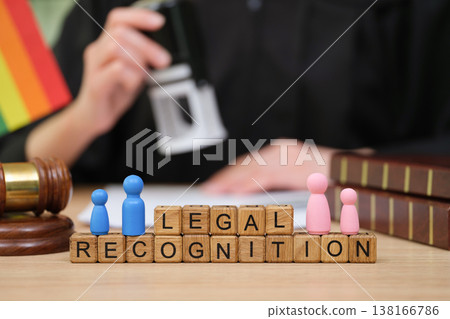 Legal recognition milestone marked by colorful tokens and a judge's stamp at a busy law office Legal recognition milestone marked by colorful tokens and a judge's stamp at a busy law office 138166786