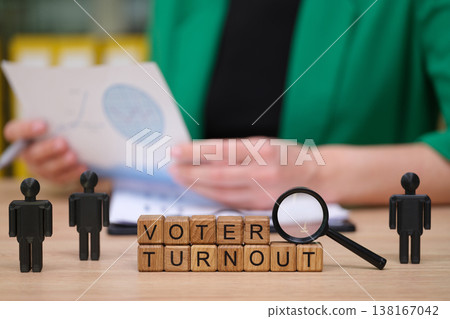 Engaging discussion on voter turnout with wooden blocks and mini figures in a bright office setting during daytime Engaging discussion on voter turnout with wooden blocks and mini figures in a bright office setting during daytime 138167042
