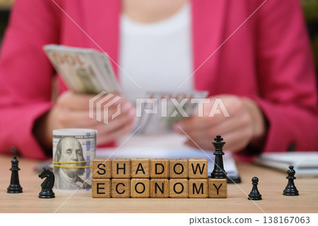 Exploring the complexities of shadow economy with chess pieces and currency in a business setting 138167063