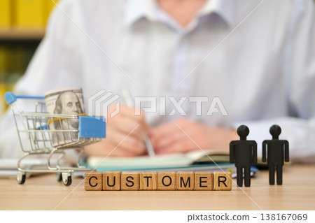Customer engagement unfolds with shopping carts and dollar bills in a casual setting Customer engagement unfolds with shopping carts and dollar bills in a casual setting 138167069