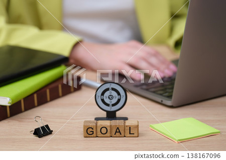 Inspiring workspace showcasing a target and goal setting near a laptop, emphasizing focus on achievement and productivity in a serene environment Inspiring workspace showcasing a target and goal setting near a laptop, emphasizing focus on achievement and productivity in a serene environment 138167096