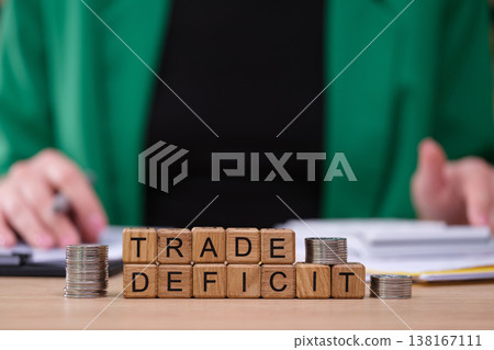 Trade deficit analysis with coins and wooden blocks showcasing economic trends in a business setting 138167111