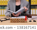 Professional defense attorney reviews case files while preparing for court in a busy law office setting surrounded by legal books 138167141