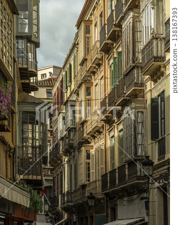 Colorful Historic Balconies and Facades on Narrow Street With Ornate Iron Railings 138167393