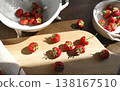 Fresh red strawberries on wooden cutting board in bright morning sunlight. Aesthetic food photography captures organic summer berries and rustic kitchenware for cottagecore slow living vibes. 138167510