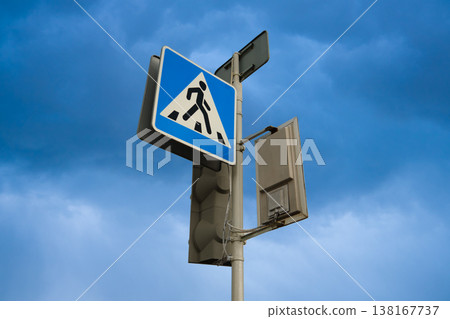 Crosswalk road sign against the backdrop of a blue sky. Pedestrian crossing 138167737