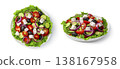 Greek salad in a flat plate close-up view from above and from the side isolated on a white background. 138167958