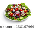 A Greek salad in a flat plate is isolated in close-up on a white background. 138167969