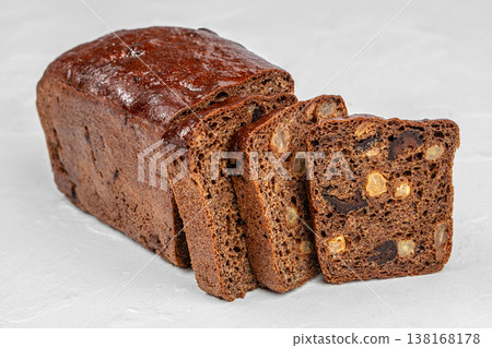 Fruit bread loaf with sliced pieces on light background Fruit bread loaf with sliced pieces on light background 138168178