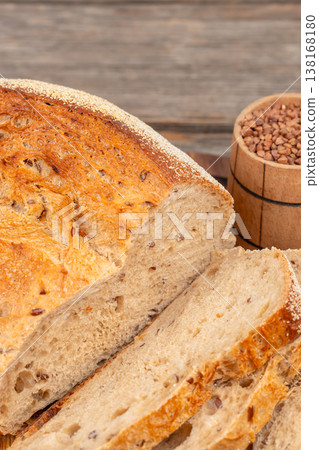 Seeded bread loaf close up with sliced pieces on wooden table Seeded bread loaf close up with sliced pieces on wooden table 138168180