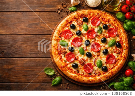 Fresh homemade pepperoni pizza with olives and basil on wooden table top view 138168568
