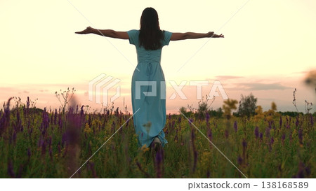 young woman with outstretched arms in wildflower meadow at sunset, woman celebrating life with raised arms in nature landscape, inspirational freedom concept with happy woman in open field, young young woman with outstretched arms in wildflower meadow at sunset, woman celebrating life with raised arms in nature landscape, inspirational freedom concept with happy woman in open field, young 138168589