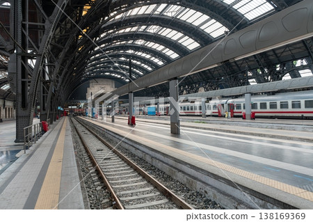 Interior of Milan Central railway station with platforms and passenger trains. Milan, Italy Interior of Milan Central railway station with platforms and passenger trains. Milan, Italy 138169369