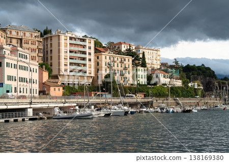 Waterfront marina in Savona with yachts and hillside residential buildings. Savona, Italy Waterfront marina in Savona with yachts and hillside residential buildings. Savona, Italy 138169380