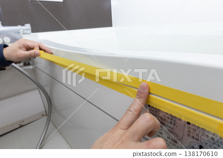 Masking when replacing caulking in the bathroom Masking when replacing caulking in the bathroom 138170610